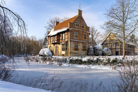 The snow-covered moated castle Haus Bisping in winter, Drensteinfurt, Münsterland, North
