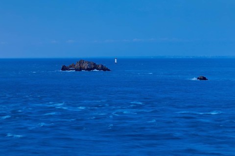 Evening view from the Pointe du Grouin with a view of the Phare de la Pierre-de-Herpin and striking
