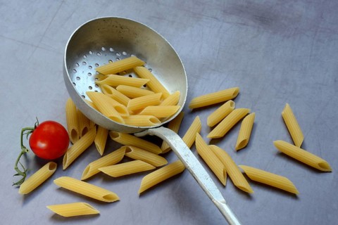 Pasta, Italian penne in a sieve ladle