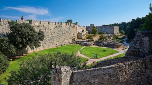 Grand Master's Palace, view of a medieval castle with courtyard and green lawn, surrounded by
