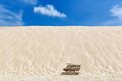Empty dune, shifting dune, white fine sand, spring clouds, minimalist landscape, symbolic image,