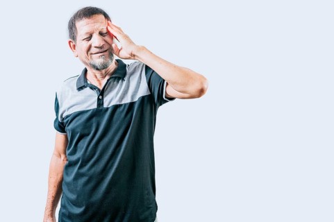 Senior person with migraine holding his head isolated. Senior man with headache isolated