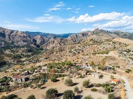 Mountains and Olive groves around Ghost Town from a drone, Pentedattilo Village, Calabria, Italy,