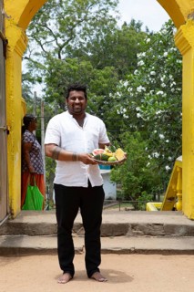 Sri Lankan man, 33 years old, with offerings at the Buddhist temple Ruhunu Maha Kataragama
