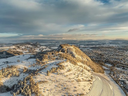 Aerial view of the snow-covered Hegau volcano Hohentwiel with Germany's largest castle ruins on a