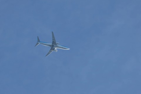 Boeing 737 jet passenger aircraft of TUI holidays flying in a blue sky, England, United Kingdom,