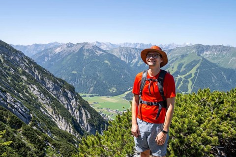 Mountaineer on a hiking trail between mountain pines, mountaineer climbing the Hochunnütz, Unnütz