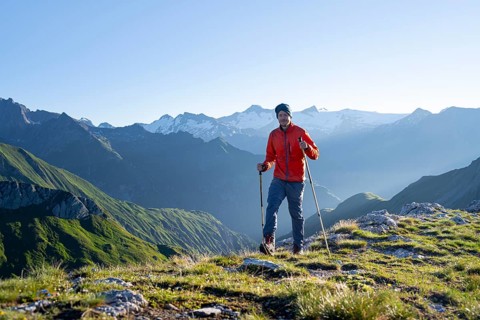 Hiker enjoying the mountain panorama in the morning, Venediger group, behind Dreiherrenkopf,