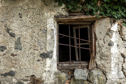 Dilapidated window of an old house in the mountain village of Bordei, Centovalli, Canton Ticino,