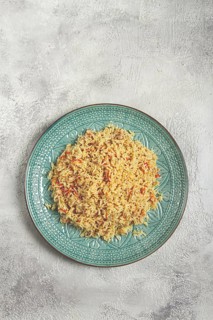Basmati rice with saffron, on a decorative blue plate, light background, homemade, no people