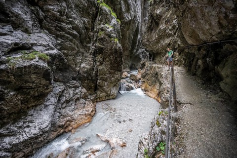 Hammersbach mountain stream in a canyon, mountaineer on a hiking trail in a gorge, Höllentalklamm,