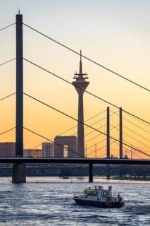 Sunset on the Rhine near Düsseldorf, skyline of the city centre with Rhine Tower, Rheinkniebrücke,