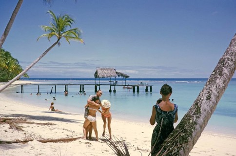 Tourists on sandy Buccoo beach Tobago, Trinidad and Tobago 1963 women playing around with man