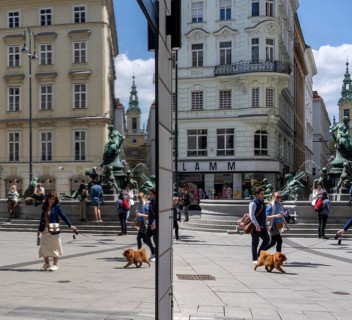 Pedestrians reflected in a shop window, Kärntner Straße at Donnerbrunnen, Vienna, Austria, Europe