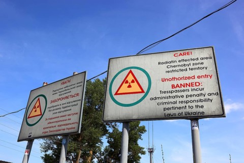 Chernobyl and Pripyat exclusion zone, sign indicating the contaminated zone, at the access road