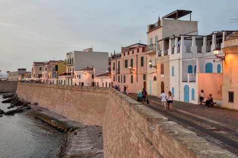 Row of houses above city wall, evening light, Alghero, Sassari Province, Sardinia, Italy, Europe