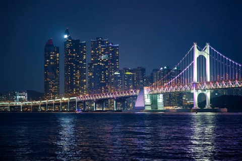 Gwangan Bridge and skyscrapers illuminated in the night. Busan, South Korea, Asia