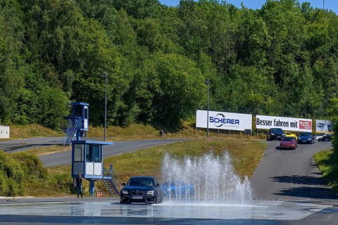 BMW M2 sports car retains control dodges obstacle in the form of water fountains on slippery