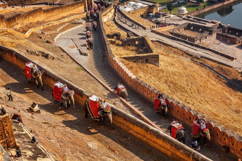 AMER, INDIA, NOVEMBER 18, 2012: Tourists riding elephants on ascend to Amer (Amber) fort,