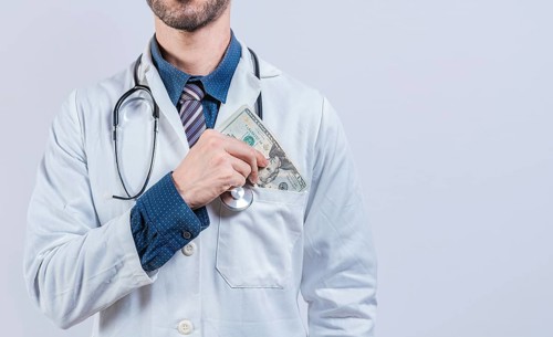 Corrupt doctor putting bribe money in pocket isolated. Dishonest doctor putting money in pocket,