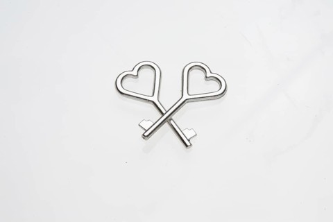 Two heart-shaped keys lie on top of each other