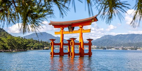 Famous red wooden torii gate UNESCO World Heritage Site Panorama on Miyajima Island, Japan, Asia