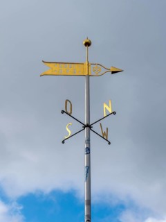 Metal wind arrow and wind chime for indicating cardinal points, north, south, east, west, Germany,