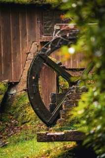 Historic Streinbrunnen fountain with mill wheel in autumn, Bad Wildbad, Kurpark, Black Forest,