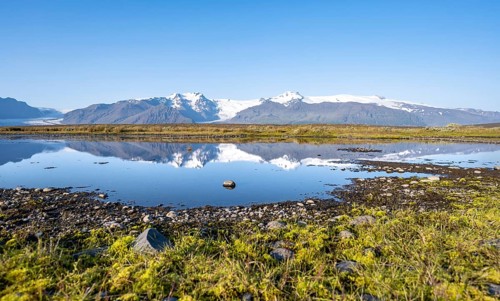Reflection in a lake, view of glacier tongues Skaftafellsjökull and Svínafellskökull, glaciated
