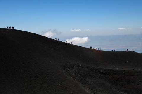 Hikers in the crater landscape of the volcano Etna, summit region, province of Catania, Sicily,