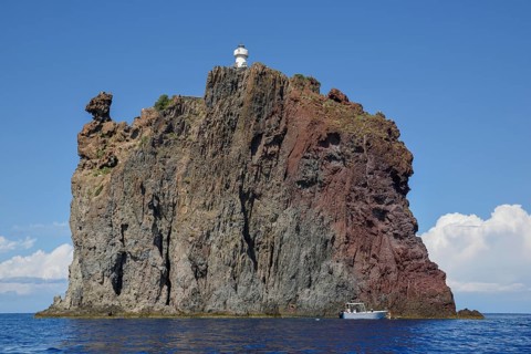 Rock island Strombolicchio with lighthouse, near island Stromboli, Lipari Islands, Tyrrhenian Sea,