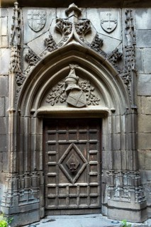 Chateaugay. Carved door in the courtyard of the castle. Puy de Dome department. Auvergne Rhone