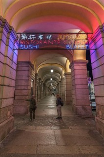 Nocturnal illuminated advertising in the historic arcade at the harbour, Genoa, Italy, Europe