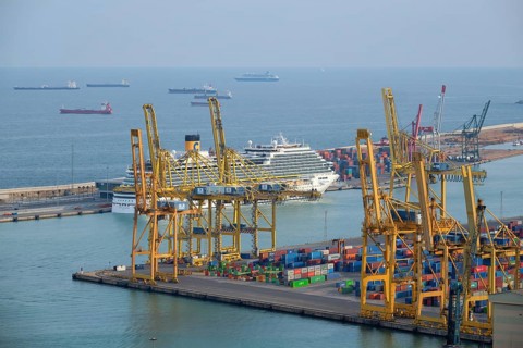 BARCELONA, SPAIN, APRIL 15, 2019: Aerial view of Barcelona port with harbour cranes and ruise ship.