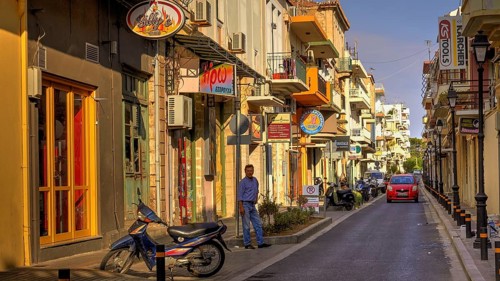 Venetian old town, old town street, moped, man, red car, lanterns, shop signs, colourful houses,