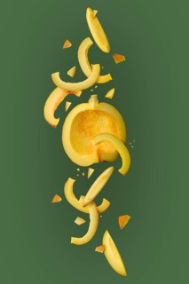 Composition with pumpkin cut on half and on slices isolated on green background