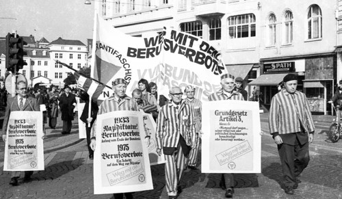 Nazi victims, some in concentration camp uniforms, demonstrated against the occupational bans