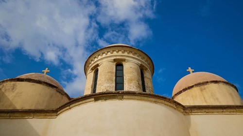 Towers with cross, round tower, ochre building, wide angle, blue sky with white clouds, Odigitrias