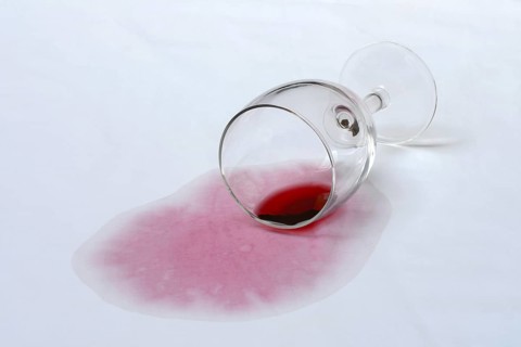 Red wine stain, overturned red wine glass on fabric, stain