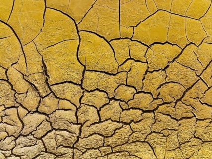 Mineral-rich cracked earth at the bank of the Rio Tinto (Red river), aerial view, drone shot,