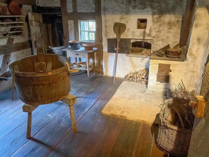 View into historical kitchen left old washing tub wooden tub back recessed in wall oven for baking