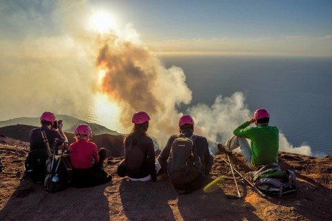 Tourists at the crater edge of the smoking layer volcano Stromboli, island Stromboli, Liparian