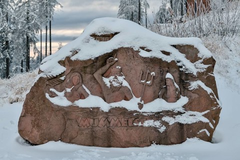 Snowy relief of the Mummelsee King on a boulder, Mummelsee, near Seebach, Black Forest,