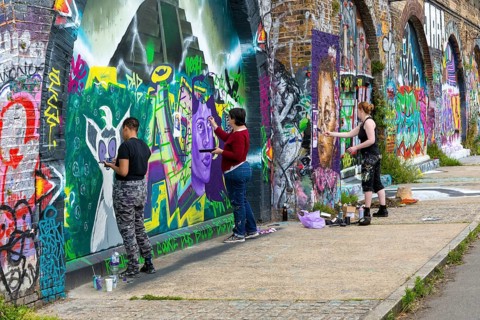 Artists painting public art murals railway arches, Deptford Creek, London S8, England, UK, artwork