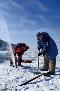Digging a hole in the ice for scuba diving, Lake Baikal, Olkhon Island, Pribaikalsky National Park,