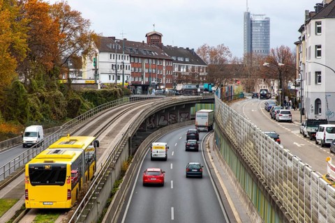 Motorway A40, Ruhrschnellweg, skyline of the city centre of Essen, exit Essen-Huttrop, track bus