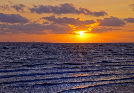 Outgoing tidal fringe in the mudflat landscape with setting sun, North Sea, Norderney Island, East