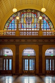 Entrance area with glass window, illuminated foyer in the spa hotel and casino in the evening,