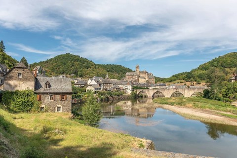 Medieval bridge over Lot with castle in village of Estaing. Aveyron, France, Europe