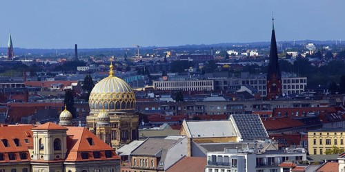 The tambour dome of the New Synagogue covered in gilded ribs in the city panorama, Berlin, Germany,